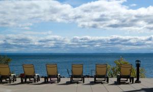 uma fila de cadeiras sentadas ao lado do oceano em Beacon Pointe on Lake Superior em Duluth