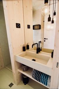 a bathroom with a sink and a mirror at MODERN BEACH VILLAS - Buqez Camp resort in Drage +31 photos