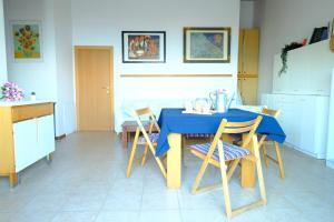 a kitchen with a blue table and chairs at Caterina Vista Mare - Pineto Vacanza in Pineto