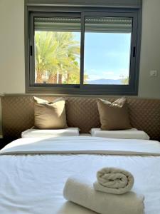 a bedroom with a large bed with a window at Esterin Royal Park Apartments Eilat in Eilat +29 photos