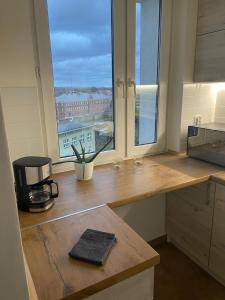 a kitchen with a counter and a large window at Apartament Centrum in Koszalin