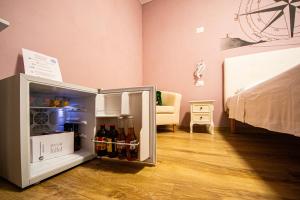 a small refrigerator in a room with drinks in it at Sweet Harbour B&B in Pesaro
