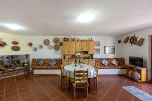 a living room with a table and a couch at Il tramonto visto da casa in Calasetta