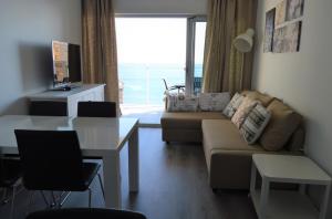 - un salon avec un canapé et une table dans l'établissement Flat El Mirador 13th floor, à Calp