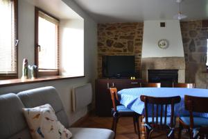 a living room with a table and a fireplace at Gite Gloria in Lannion