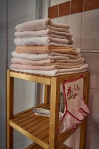 a pile of towels on a rack in a bathroom at Ferienhaus Pucher in Grundlsee