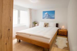 Postel nebo postele na pokoji v ubytování Casa delle Stelle by Zermatt Premium Apartments