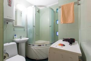 a bathroom with a shower and a toilet and a sink at Covent - Garden - Kharkiv in Kharkiv +116 photos