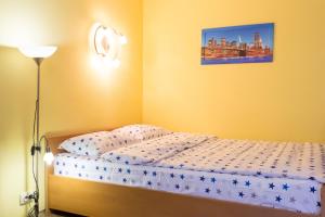 a bedroom with a bed and a lamp at Covent - Garden - Kharkiv in Kharkiv