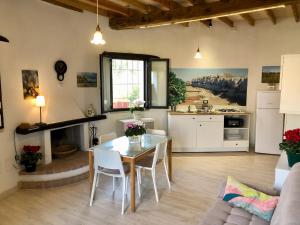 a kitchen and living room with a table and chairs at Masseria La Torre in Maglie
