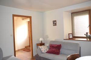 a living room with a couch and a window at Gite Gloria in Lannion