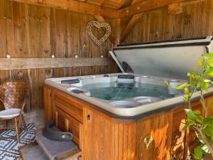 a jacuzzi tub in a wooden house at Chambre d'hôtes La Ferme de la Croix. in Saint-Avit-Sénieur