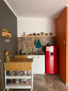 a kitchen with a red refrigerator and a counter at Casa Campanario - San Pedro de Atacama, Desconéctate! in San Pedro de Atacama