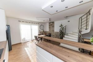 a kitchen and dining room with a table and stairs at Deluxe Apartment Stunning view in Jadranovo