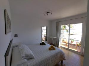a bedroom with a bed with two teddy bears on it at Mandala in Tías