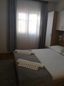 a bedroom with a bed with two scales on it at Apartments Stipanovic in Biograd na Moru