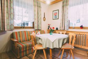 a dining room with a table and a chair at Pichlerhof Sommmercard - Urlaub am Bauernhof in Birnberg +19 photos