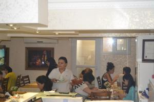 a group of people sitting at tables in a room at New Fatih Hotel in Istanbul