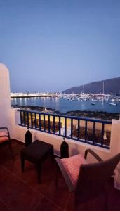 einen Balkon mit Blick auf das Wasser und die Boote in der Unterkunft Suite Marrakech Beach, La Graciosa. in Caleta de Sebo