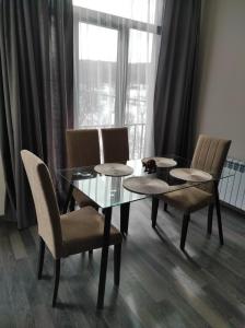 a dining room with a table and chairs and a window at Sunny apartment in Kechi House, Tsaghkadzor in Tsaghkadzor