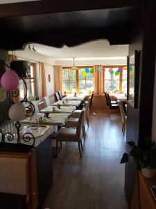 a long dining room with long tables and chairs at Backer-Ferdl Panzio in Hinterstoder