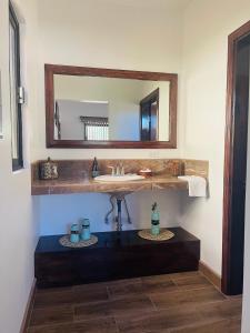 a bathroom with a sink and a mirror at Finca Chavez in Ensenada