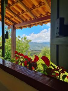 a window with a view of a mountain view at Estúdio Amor: refúgio à dois nas montanhas in Lavras Novas