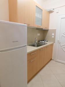 a kitchen with a stainless steel refrigerator and a sink at Anna House 2 in Sarti