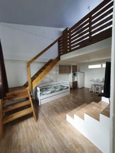 a room with a staircase and a living room at Pousada Korb in Santo Amaro da Imperatriz