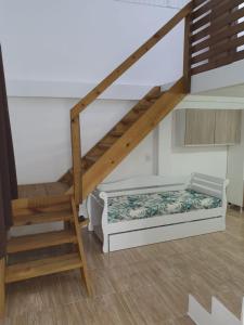 a bedroom with a bed under a stair case at Pousada Korb in Santo Amaro da Imperatriz +83 photos