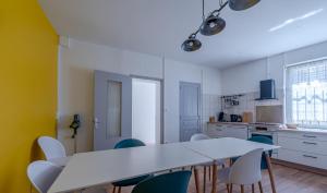 a kitchen with a white table and chairs at Drissia&Othman Grande Casa in Carcassonne