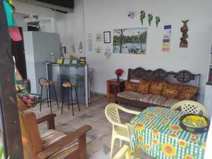 a living room filled with furniture and a table at Pousada Solar Encanto do Marajó in Soure