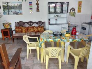 a dining room table and chairs in a kitchen at Pousada Solar Encanto do Marajó in Soure