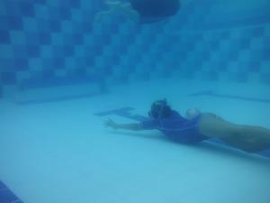 a woman swimming in a pool in the water at La Toscana Campestre in Viotá