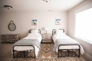two twin beds in a room with a rug at *Spacious, Modern Mountain Vacation Home!* in Provo