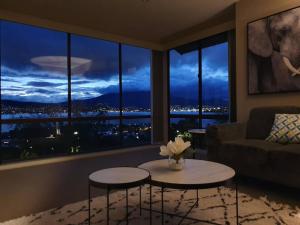 a living room with two tables in front of a window at Hobart panoramic view with Spas in Hobart