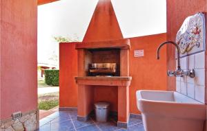 a kitchen with an orange wall with a stove at Beach Front Home In Ca- With Wifi in Monte Nai