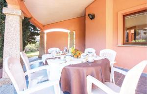 a table with white chairs and a table with food on it at Beach Front Home In Ca- With Wifi in Monte Nai +15 photos