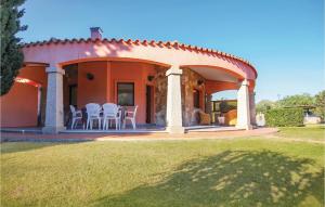 an orange house with white chairs and a patio at Beach Front Home In Ca- With Wifi in Monte Nai