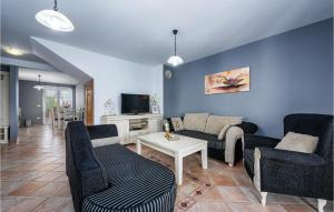 a living room with a couch and chairs and a tv at Beautiful Home In Lovrecica With Outdoor Swimming Pool in Lovrečica
