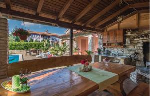 a kitchen with a wooden table and a view of a pool at Stunning Home In Labin With Outdoor Swimming Pool in Labin