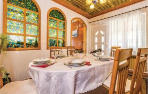 a dining room with a table and chairs and stained glass windows at Stunning Home In Krasica With Kitchen in Krasica