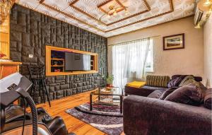 a living room with a couch and a tv at Stunning Home In Krasica With Kitchen in Krasica