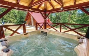 a jacuzzi tub in the middle of a cabin at Lovely Home In Vrbovsko With Kitchen in Jablan