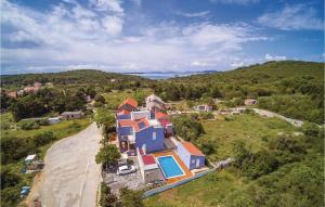 an aerial view of a house on a hill at 2 Bedroom Lovely Apartment In Veli Rat in Verunić