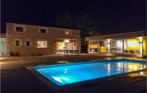 a swimming pool in front of a house at night at Stunning Home In Saint Rémy in Saint-Rémy