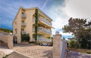 a large yellow building with white balconies on it at Beautiful Apartment In Crikvenica With Wifi in Crikvenica