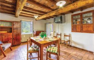 a kitchen and dining room with a table and chairs at Val Di Vaiana in Renaio