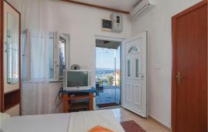 a bedroom with a bed and a television on a table at Beautiful Apartment In Omis With Wifi in Omiš