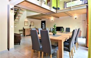 a dining room with a wooden table and black chairs at Amazing Home In Sauveterre With Wifi in Sauveterre